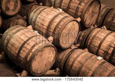 Wine Barrels Stacked In The Old Cellar Of The Winery.