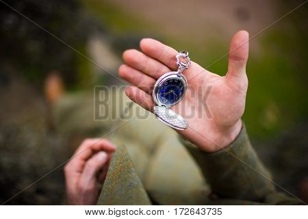 Man in suit looking at his pocket watch. The concept of expectations.