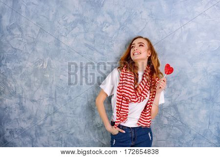 Pretty girl with candy. Wide shot with copy space