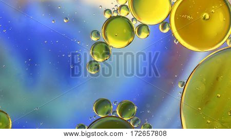 Oil in water abstract circles on a colorful blue background