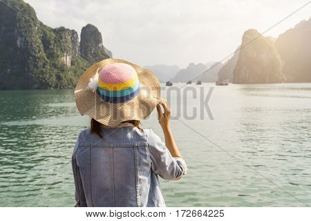 Woman traveler looking beautiful natural view at Halong bay in Vietnam