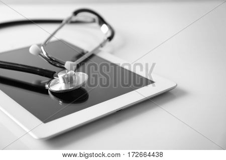 Stethoscope and tablet pc on white background