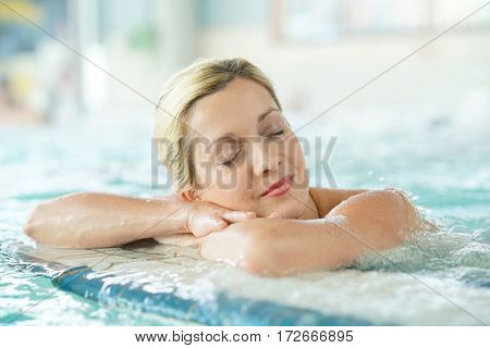 Middle-aged woman enjoying thermal bath in thalassotherapy center