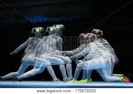 RIO DE JANEIRO, BRAZIL - AUGUST 13, 2016: Sofya Velikaya of Russia (L) and Mariel Zagunis of United States compete in the Women's Sabre Team of the Rio 2016 Olympic Games at Carioca Arena 3