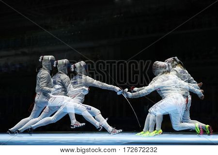 RIO DE JANEIRO, BRAZIL - AUGUST 13, 2016: Sofya Velikaya of Russia (L) and Mariel Zagunis of United States compete in the Women's Sabre Team of the Rio 2016 Olympic Games at Carioca Arena 3
