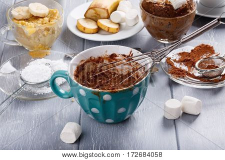 Quick chocolate cake with marshmallow in a glass mug from microwave. Cooking.