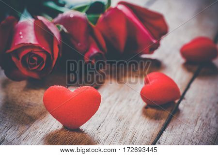 Red hearts and roses on wooden board.Valentines Day background concept Wedding day.Vintage tone