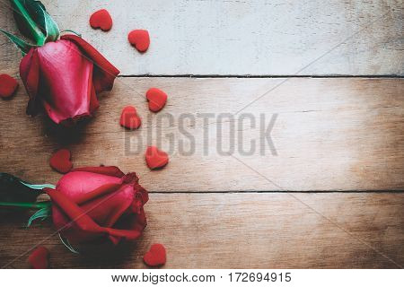 Red roses and heart on wooden background with copy space.Valentines Day background concept Wedding day.Top view vintage tone