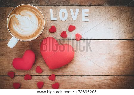 Caption word love heart and cup of coffee on wooden background with copy space.Valentines Day background concept Wedding day.Top view vintage tone