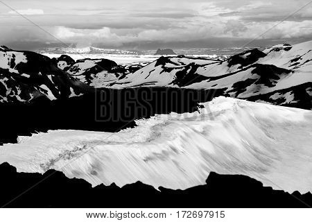 Unreal view from the volcano Ok with its snow-filled crater to the snowfields and glaciers of Thorisdalur. The large Langjokull glacier is in the background.