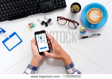 CHIANG MAITHAILAND - FEB 022017 : Man hands holding a iPhone 6s with Microsoft Outlook application. Microsoft Outlook is used for emails and also personal management of information.