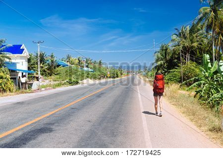 lonely girl is hitchhiking on the road Cambodia