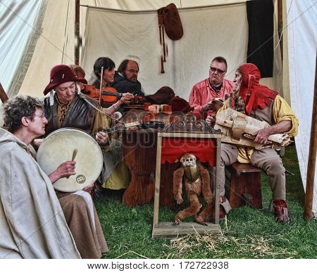 Nogent le RotrouFrance 12.05.2013: Group of medieval people singing in their tent using obsolete musical instruments during the Percheval Medieval Festival near the Saint Jean Castle in Nogent le Rotrou.