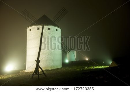 Windmills on a dark thick foggy night