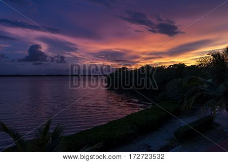 Sunrise on the caribbean coast with orange clouds