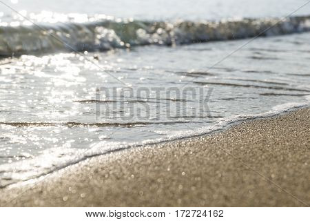 The sand of the beach washed by the waves of the sea