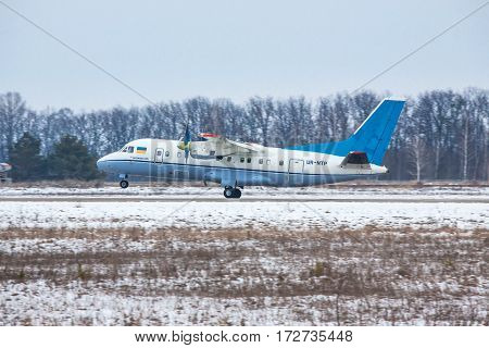 Kiev Region Ukraine - February 1 2011: Antonov An-140 regional passenger plane is taking off from the runway on a winter day