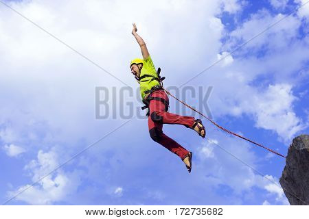 The first jump off the cliff with a safety rope.