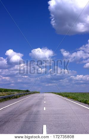 Asphalt road over blue sky background of sunny day.