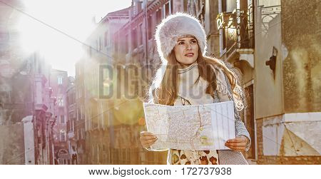 Elegant Tourist Woman In Venice, Italy In Winter With Map