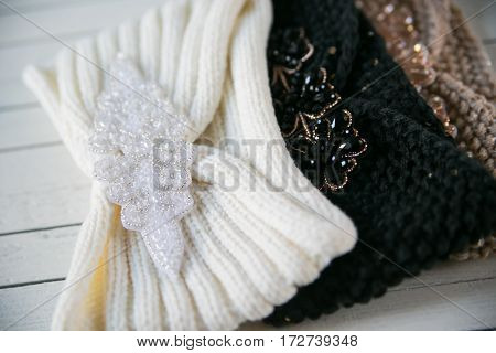 two skeins of wool and knitted headband gradient on the wooden background
