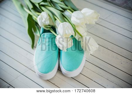 women's accessories, shoes lying on wooden background