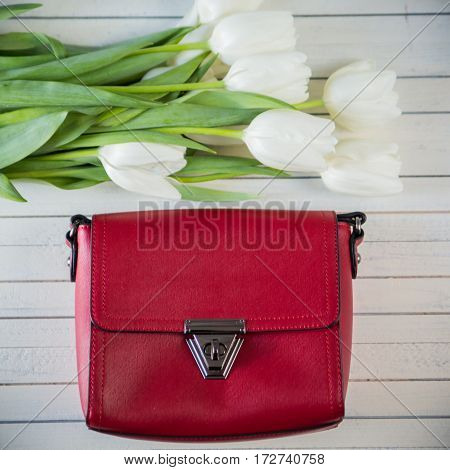pink woman bag with flowers on wood background