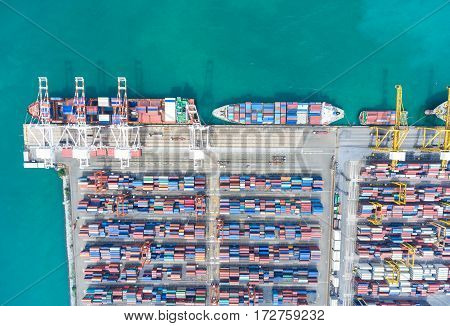 container ship in import export and business logistic. By crane Trade Port Shipping. Tugboat assisting cargo to harbor. Aerial view.