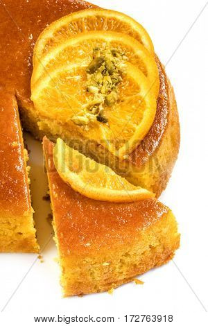 Flourless orange cake over white.  Wedge cut out.