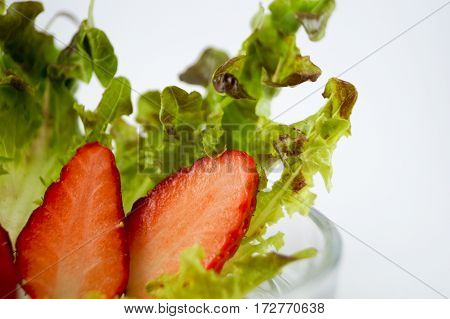 white background and strawberry cut pieces and fresh vegetable so delicious and healthy