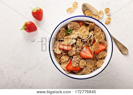 Multigrain wholewheat healthy cereals with fresh berry for breakfast overhead shot on white