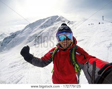 Happy skier in winter ambience on mountain