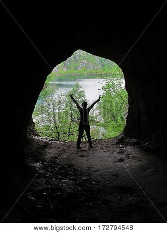 shadow of a woman with arms open isolated in a cave in Plitvice National Park in Croatia