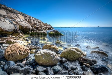 Rocks and blue waters at a beach in LImassol Cyprus
