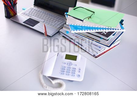 Group of multicolored office folders and glasses.