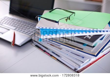 Group of multicolored office folders and glasses.