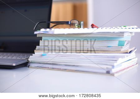 Group of multicolored office folders and glasses.