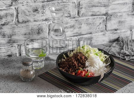 Beef taco rice and cabbage salad on a gray background. Delicious lunch