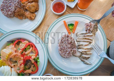 Eating for good healthy low cholesteral but high proteen Salad rice chicken and orange juice