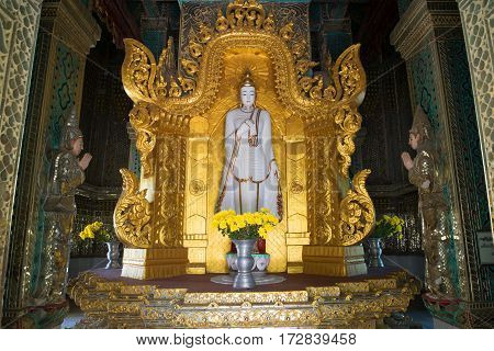 AMARAPURA, MYANMAR - DECEMBER 20, 2016: The sculpture of standing Buddha in the interior of the stupa Mahar Gandar Yone monastery
