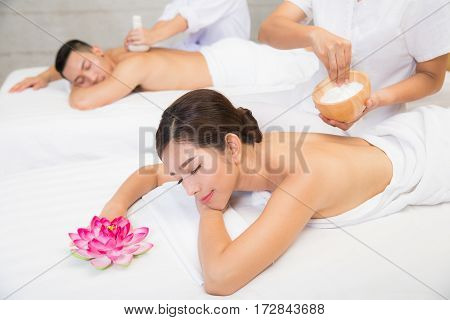Young couple lying on the massage table and smiling spa concept