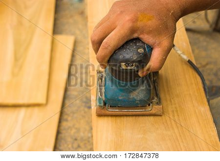 Carpenter's hands using sander on wooden  in workshop,Electrical sander tool,power sander,Man Working with an Electric Sander