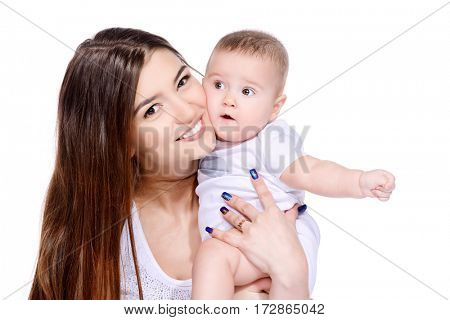 Happy mammy tenderly embracing her small baby. Family concept. Healthcare, pediatrics. Isolated over white. Copy space.