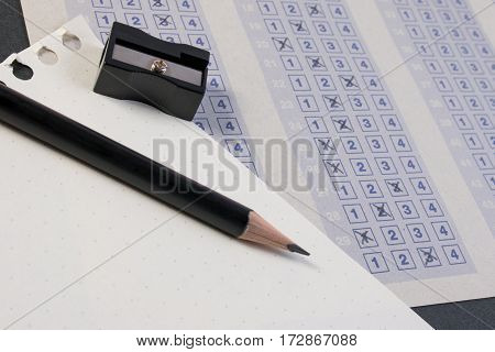 Filling Out In Answer Sheet With Pencil, Sharpener And Paper Reduction. Cross The Right Answer In Th