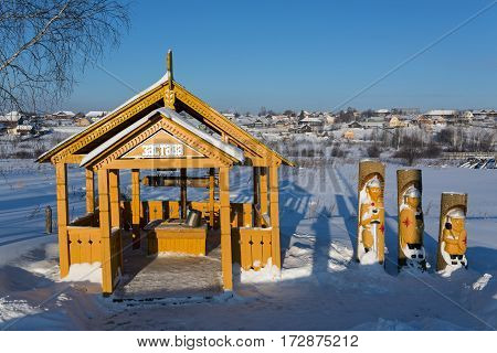 VISIM/ RUSSIA - JANUARY 8. Wooden well and statues of the three Russian heroes in the old believer village Visim on January 8, 2015. Russia.