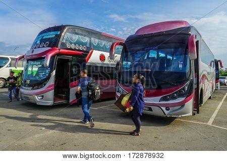 Menumbok,Sabah-Aug 19,2016:People running up to the bus in bus terminal at Menumbok,Sabah.People used to take bus from Kota Kinabalu to Menumbok then ferry to Labuan island to enjoy tax free shopping