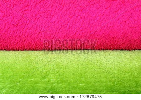 colorful background of textured blankets detail of stack with green and pink material