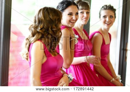 Adorable bridesmaids have fun while waiting for a bride