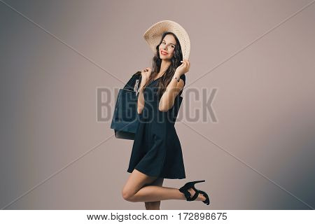 Beautiful woman with shopping bags. Studio shoot