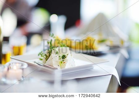 Different Kinds Of Wine Snacks And Variuos Cheeses On White Table